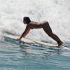 Surfer girl getting through a wave @ Surfers Point Barbados